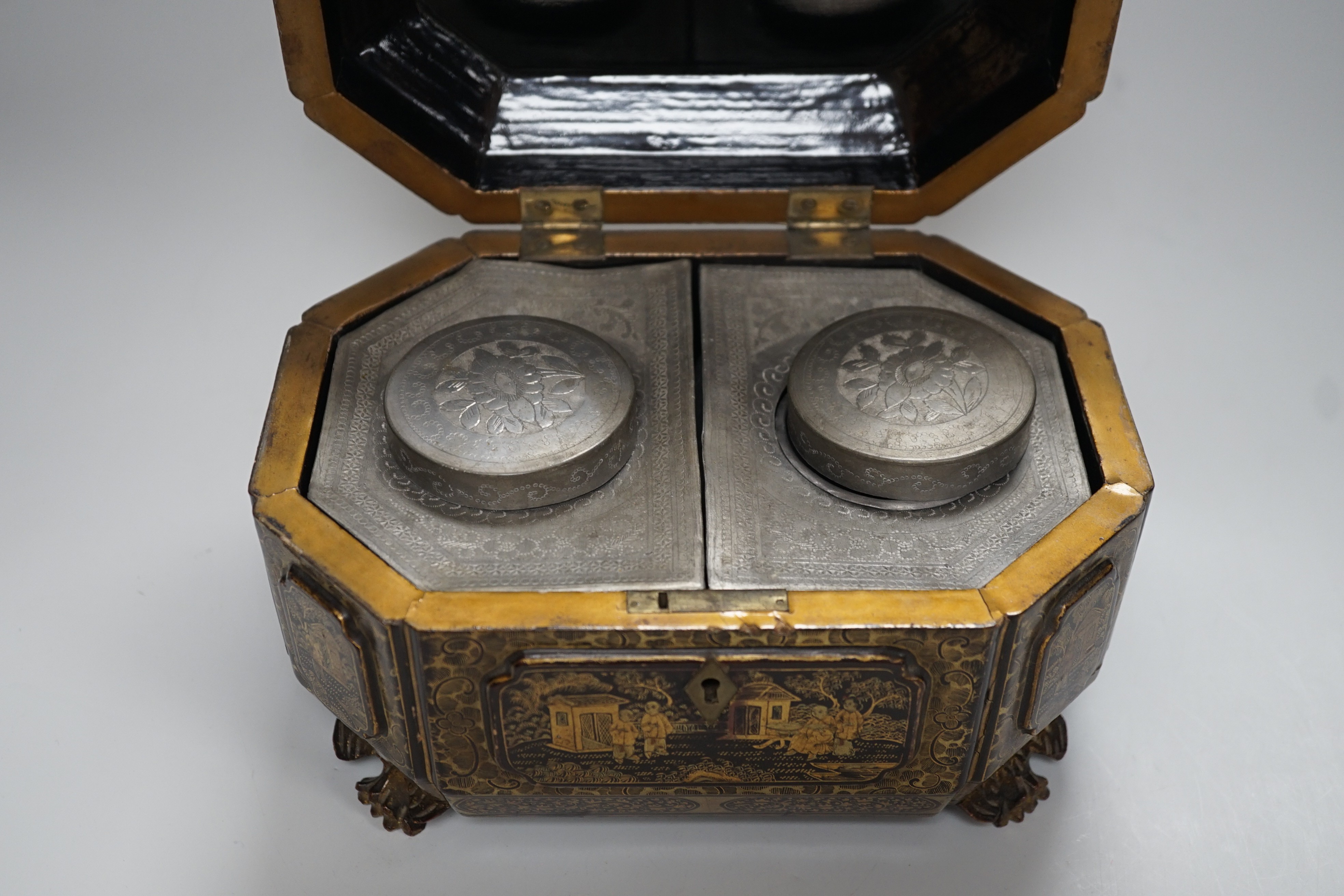 A 19th century Chinese chinoiserie lacquered sarcophagus form tea caddy, pewter lined interior with bone handles, 23cm